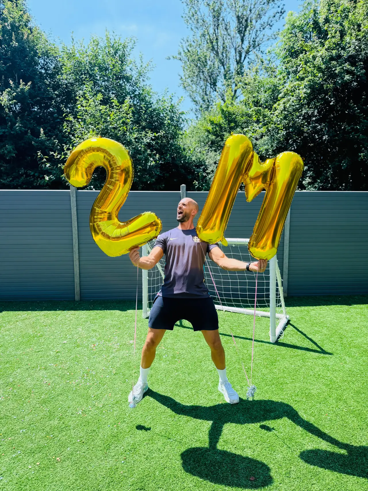 Daniel celebrating with gold balloons